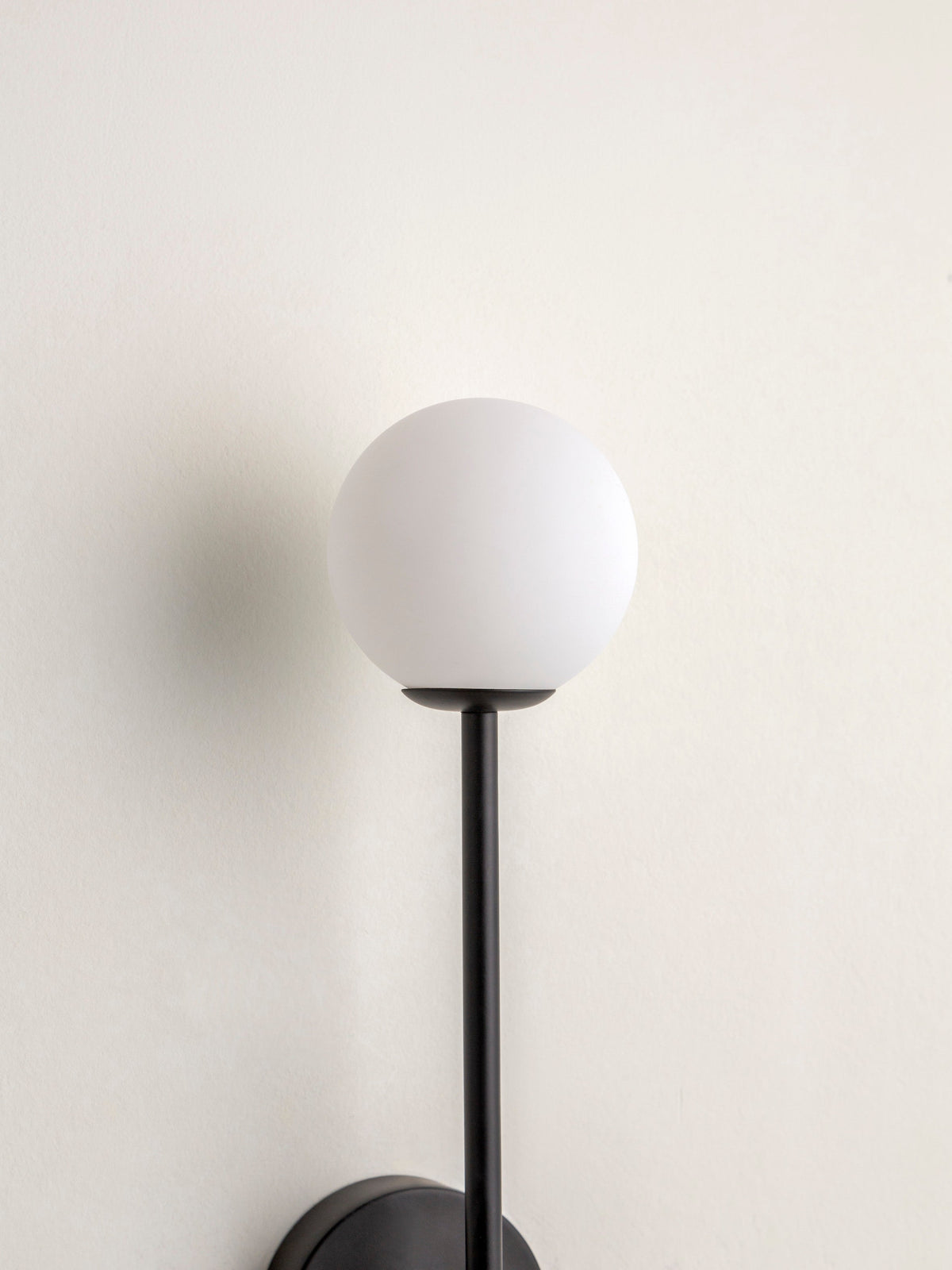 Chelvara - matt black and opal wall light