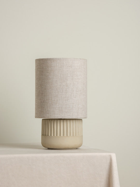 Enza - warm white ribbed concrete table lamp